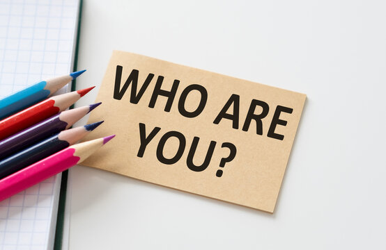 Who Are Yous text on a card on a white background next and colored pencils