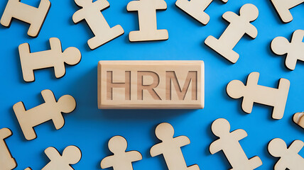 Obraz premium HRM: Human Resources Management, Employee Engagement, Recruitment, and Organizational Growth, human resources management concept. Wooden figures on the blue background, hrm copy space, hrm background