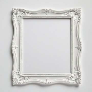 Empty ornate white picture frame on plain background