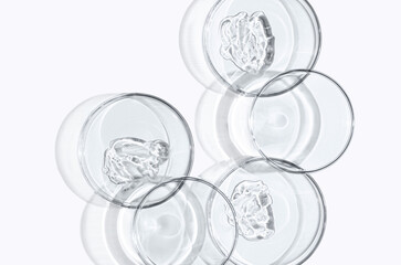 Skin serum or face wash gel in a Petri dish. For cosmetic procedures. White background