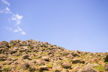 A rocky hill on a clear sky summer day