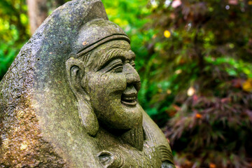 Obraz premium Statue of a buhda face. Buhda is a common religious in Asian countries. The theology saying to do good deeds and act kind to people. Karma will hit with people who scam or harm others