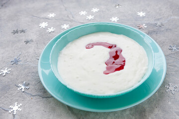 Traditional Scandinavian Norwegian christmas dessert rice cream riskrem with red berry sauce