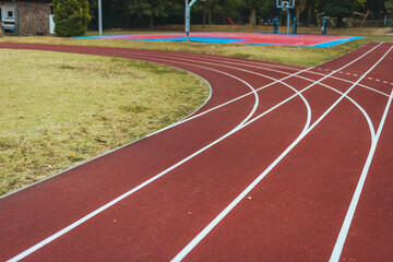 Curved Running Track and Basketball Court in Outdoor Sports Complex