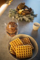 Waffles with chocolate sauce for christmas. Homemade fresh golden waffles delicious breakfast. Top side close up view of healthy seasonal refreshment diet. 