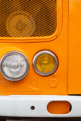Close-Up of Vintage Vehicle Headlights and Grille vertical
