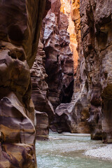 Jordan. Wadi Mujib. Wadi el-Mujib canyon with steep cliffs. Wadi Mujib River, also known as Arnon Stream, flows between high cliffs at bottom of narrow canyon among impressive rock formations.