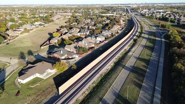 Continuing development of precast concrete walls noise barriers, sound mitigation light railroad Belt Line Road in Coppell, suburbs Dallas Fort Worth, block wheel engine noise by trains, flyover