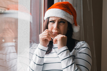 sad and lonely young woman crying at home on christmas