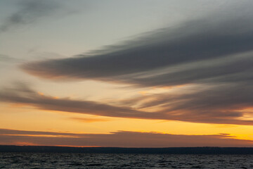 a sunset with clouds and a sunset on the horizon.