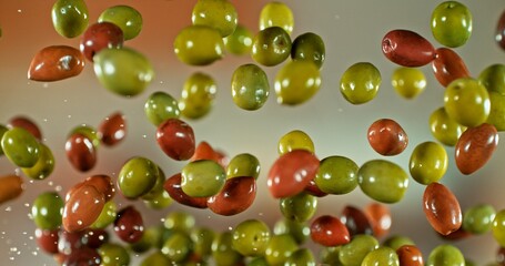 Freeze Motion of Flying Black and Green Olives.