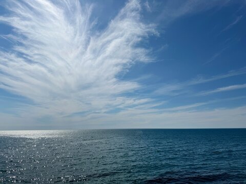 Sea blue glittering water and beautiful sky cirrus cloud.