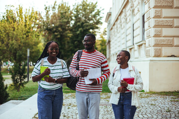 Group of Smiling Young Students Walking Together on University Campus