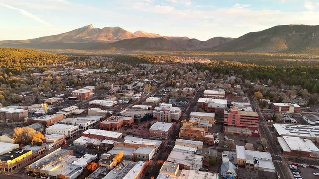 Aerial panorama of downtown Flagstaff in the morning sunlight, train station, the old town and the San Francisco mountains in the background	