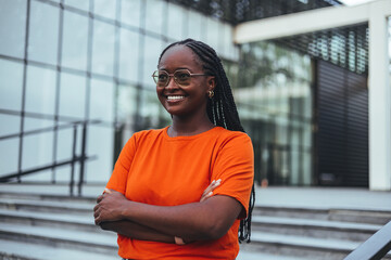 Confident Woman Standing Outside a Modern Glass Office Building