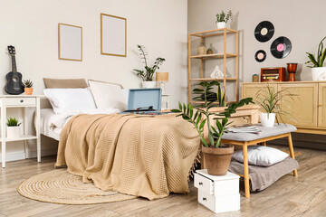 Interior of bedroom with plants, record player and vinyl disks