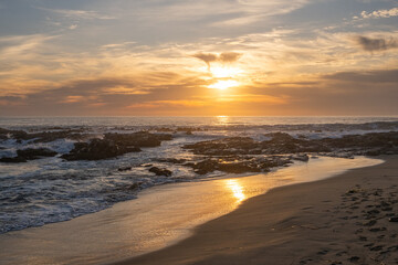 setting sun over the ocean at Bean Hollow State Beach California USA