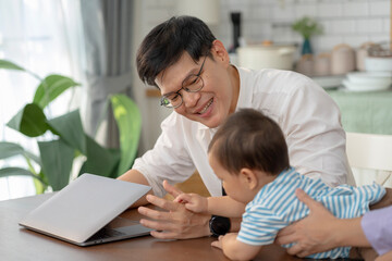 Asian baby and families who have to work while raising children at home