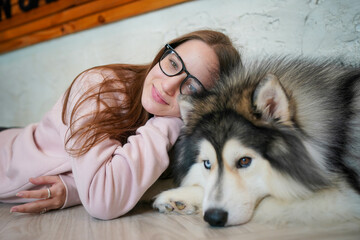 Girl with a husky puppy in a snowy winter setting