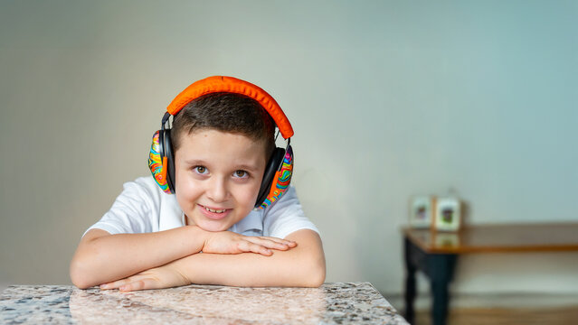Autistic Boy Smiling with Noise-Canceling Headphones for Sensory Comfort