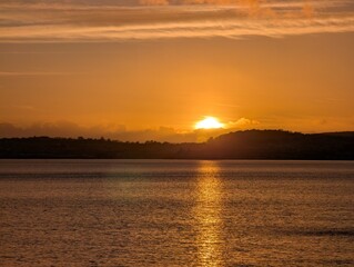 Golden sunset across the sea as the sun goes down.