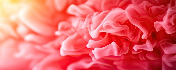 A vibrant close-up of swirling pink and red hues, resembling abstract waves or smoke, creating a soft and dreamy atmosphere.
