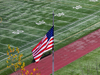 American football field with an American flag in the foreground