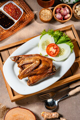 Bebek Goreng, Traditional Fried Duck. Popular Menu came from Madura, East Java. served with sambal, cucumber, tomato and lettuce.