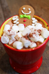 Cup of Hot Chocolate with Gingerbread Man Cookies and Pile of Marshmallow Candies