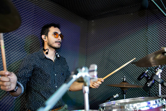 young latin drummer in a recording studio