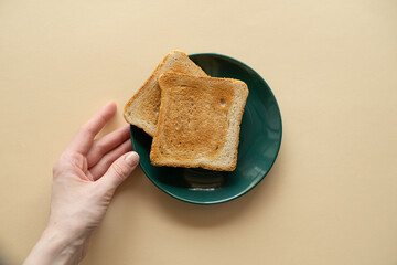 Vegan fried toast on a plate and a hand on a yellow background, healthy eating, healthy breakfast.