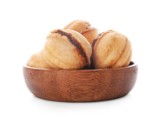 Wooden bowl of sweet walnut shaped cookies with boiled condensed milk on white background