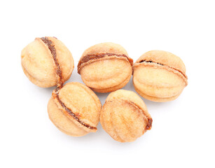 Many sweet walnut shaped cookies with boiled condensed milk on white background