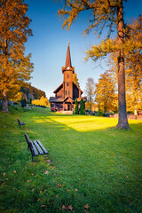Impressive autumn view of wooden St. Anne's Catholic Church. Magnificent evening scene of Javorina village, Slovakia. Amazing landscape of High Tatras National Park. Traveling concept background.