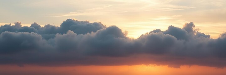 Fototapeta premium Soft colours of sunrise peek through layered cloudy skies, natural background, gentle morning
