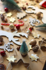 Various Christmas decorations in neutral colors on wooden background. Selective focus.
