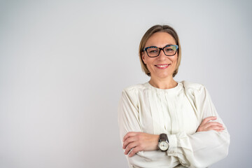 Beautiful woman smiling with crossed arms. Happy Self-Assured Woman On Isolated Background. Happy female designer standing isolated