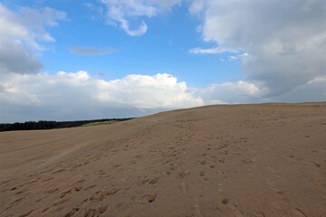 sand dune without people and the blue sky with clouds