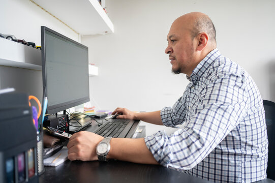 Latin man using computer working at home