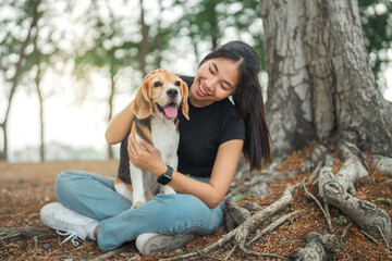 Happy asian woman playing with dog together in public park outdoors, Friendship between human and their pet