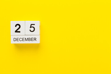 Calendar with date December 25 on color background, top view
