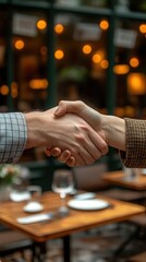 Handshake Between Two Professionals in a Cozy Outdoor Cafe