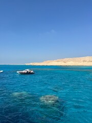 Hurghada, Egypt - November 9, 2024: Yacht and snorkeling boats anchored in clear blue waters rich in coral reefs. Giftun island (Paradise island) near Hurghada, Red Sea coast.