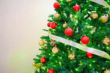 Macro close up view of dressed up christmas tree with bright vibrant colorful decorated baubles and glowing light bulbs ornaments. Winter festive holiday season. New year merry xmas holiday. 