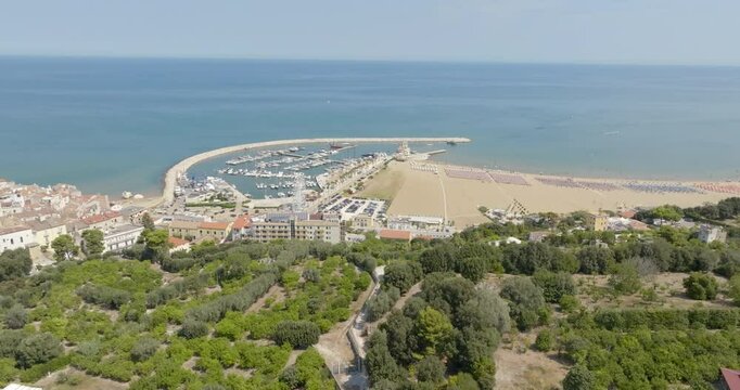 Aerial view of Levante beach and the marina of Rodi Garganico. It is a tourist destination in Gargano, in the province of Foggia, Puglia, Italy. The town overlooks the Adriatic Sea.