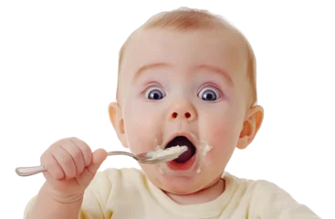 Fotobehang Surprised baby eating food from a spoon, isolated on transparent cutout background  © PNGuin Studio