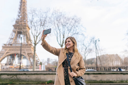 Woman Taking Selfie Near Eiffel Tower
