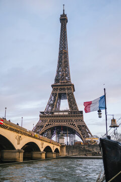 Eiffel Tower and Bridge with French Flag from River
