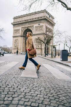Woman Walking Across Crosswalk by Arc de Triomphe