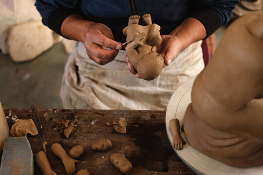 Artisan Sculpting a Clay Figure
